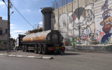 a-petrol-truck-drives-past-murals-painted-on-the-separation-barrier-in-bethlehem-in-the-west-bank-palestinian-territories_r8qs3if6ll_thumbnail-full01