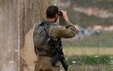 An Israeli soldier positioned near the northern town of Metula monitors the fence with Lebanon, 21 May 2022 (AFP).jpg