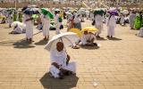 Muslim pilgrims use umbrellas to shade themselves from the sun as they arrive at the base of Mount Arafat, also known as Jabal al-Rahma or Mount of Mercy, during the annual hajj pilgrimage on June 15, 2024 Fadel SENNA _.jpg
