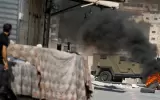 a-palestinian-man-looks-at-an-israeli-military-vehicle-during-an-israeli-raid-in-tubas-in-the-israeli-occupied-west-bank-october.webp