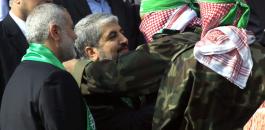 A-Palestinian-member-of-the-Ezzedine-al-Qassam-brigades-hugs-Hamas-chief-Khaled-Meshaal-as-Hamas-prime-minister-Ismail-Haniya-looks