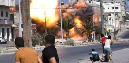 Palestinian-men-look-on-as-a-bomb-from-an-Israeli-air-strike-hits-a-house-in-Gaza-City