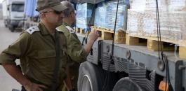 israeli-soldiers-inspect-a-humanitarian-aid-truck-before-it-enters-gaza-erez-border-crossing-july-2014