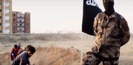 isis-soldier-posing-in-front-of-people-digging-their-own-graves