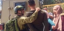 فتاة فلسطينية تحاول منع اعتقال خطيبها في كلية العروب 