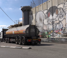a-petrol-truck-drives-past-murals-painted-on-the-separation-barrier-in-bethlehem-in-the-west-bank-palestinian-territories_r8qs3if6ll_thumbnail-full01