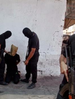 Hamas militants prepared to execute a person suspected of collaborating with Israel on Friday in Gaza City. Credit Reuters