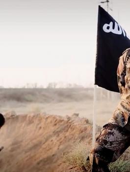 isis-soldier-posing-in-front-of-people-digging-their-own-graves