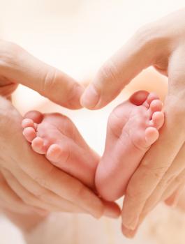 bigstock-Baby-feet-in-mother-hands-Tin-59073902