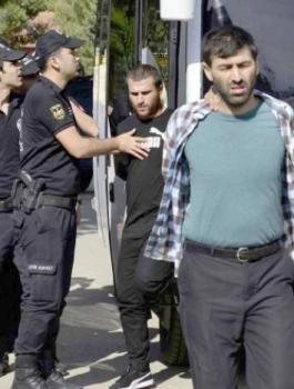 Turkish police officers escort men, suspected of being ISIS-ap