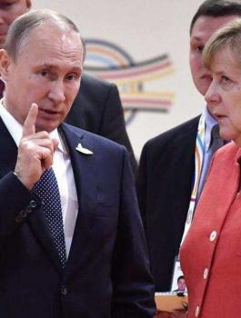 بوتين وميركل واللاجئيين السورييين 