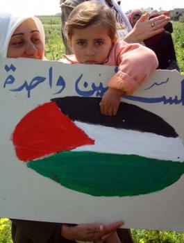 Palestinian_child_holds_a_sign_on_Land_Day