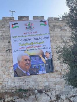 ازالة لافتة تحمل صور الرئيس في القدس 