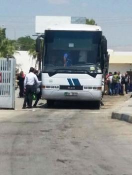 ركاب ينتظرون الصعود إلى حافلة في جسر الملك حسين -(الغد).jpg