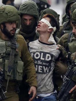Israeli-occupation-soldiers-while-abducting-Palestinian-child-Fawzi-14-in-occupied-West-Bank-city-of-Al-Khalil..jpg