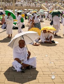 Muslim pilgrims use umbrellas to shade themselves from the sun as they arrive at the base of Mount Arafat, also known as Jabal al-Rahma or Mount of Mercy, during the annual hajj pilgrimage on June 15, 2024 Fadel SENNA _.jpg