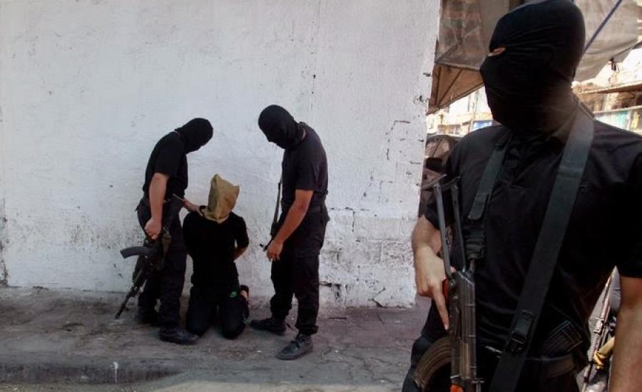 Hamas militants prepared to execute a person suspected of collaborating with Israel on Friday in Gaza City. Credit Reuters