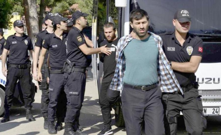 Turkish police officers escort men, suspected of being ISIS-ap