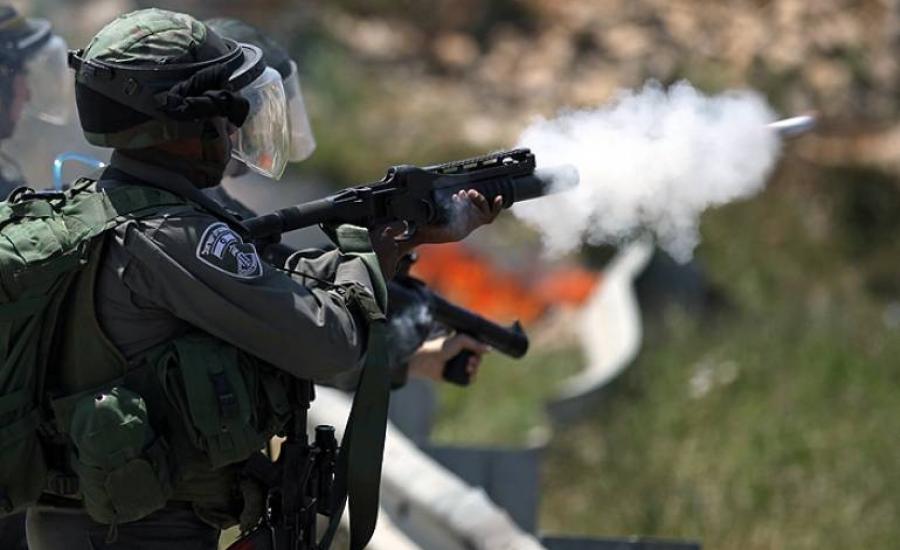 Israeli occupation soldier firing tear gas canisters at protestors - (Archives).jpg