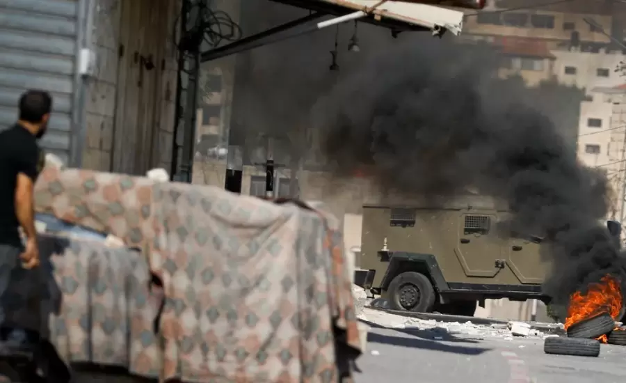 a-palestinian-man-looks-at-an-israeli-military-vehicle-during-an-israeli-raid-in-tubas-in-the-israeli-occupied-west-bank-october.webp